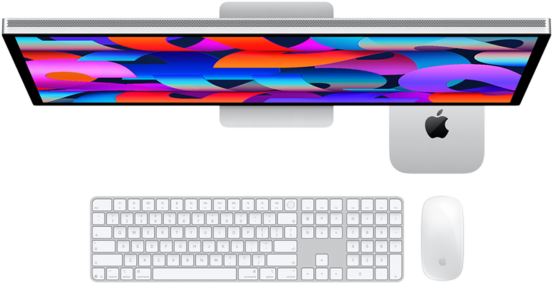 Apple Mac mini M6 with Studio Display, Magic Keyboard, and Magic Mouse, viewed from above in a workspace setting.