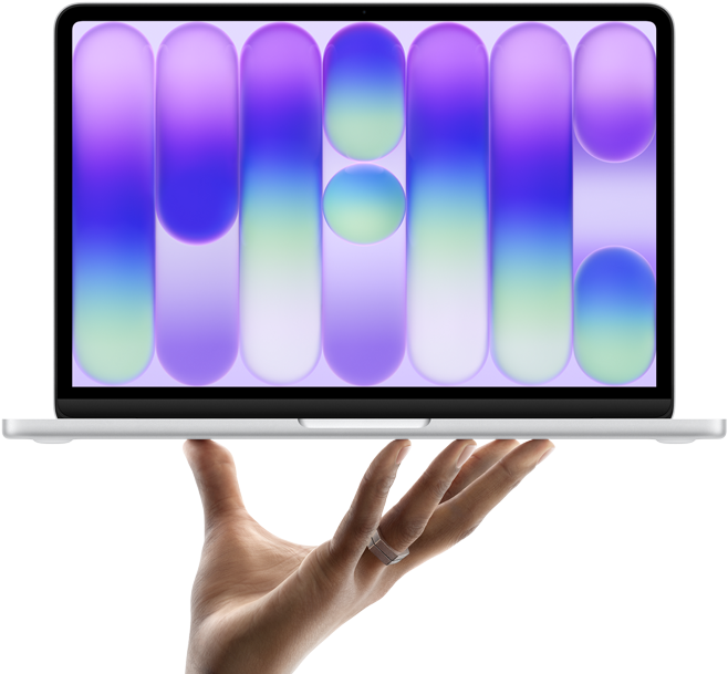 Apple MacBook Neo. A hand holds up the new MacBook Neo in silver.