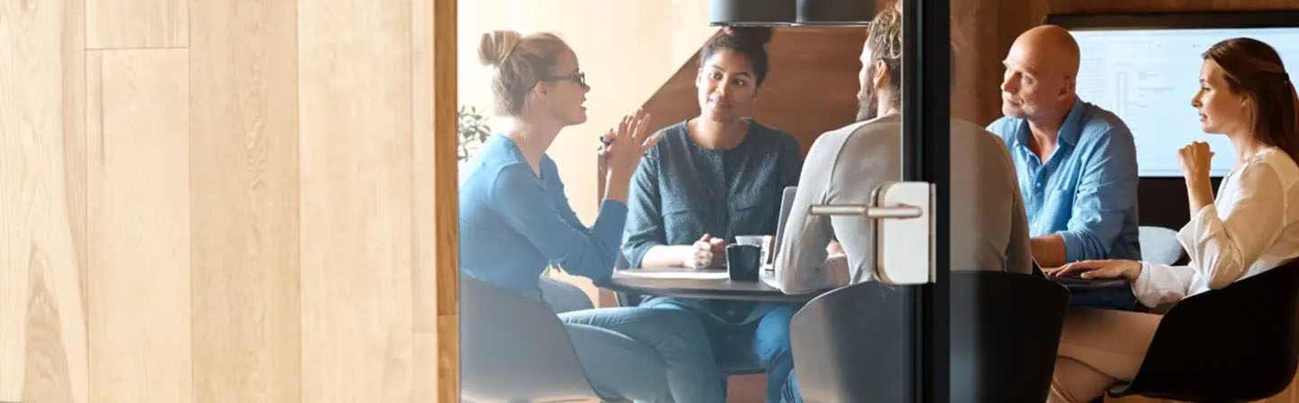 Colleagues sitting in meeting room