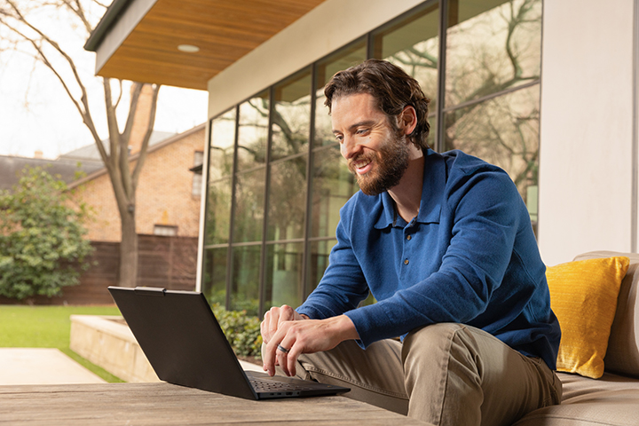 One man on hybrid work on a laptop.