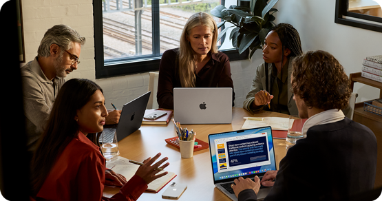 Apple MacBook Pro M5. Creative woman working at desk.