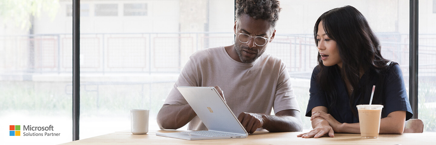 Two colleagues working with Microsoft Surface