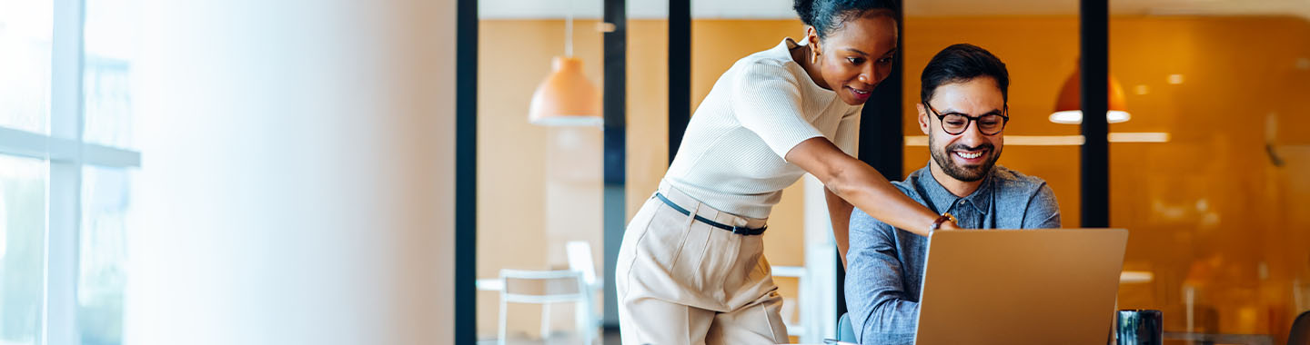 Two colleagues working on a notebook