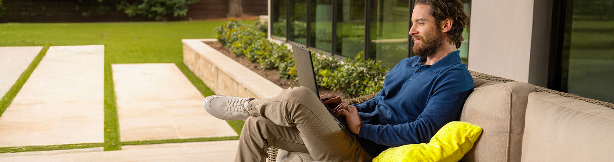 Man sitting on a lounge working on a laptop
