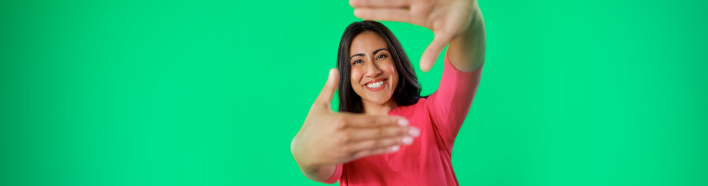 Smiling woman with long brown hair in a red sweater.